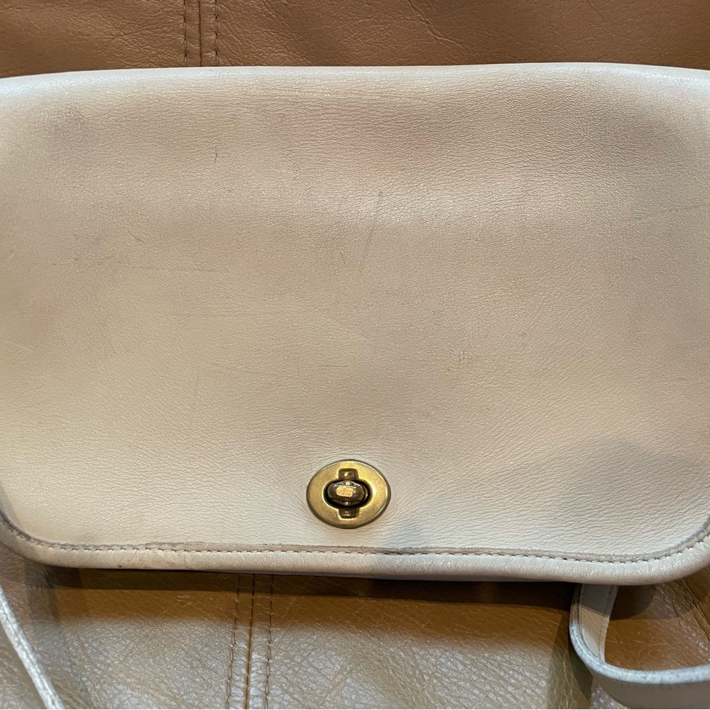 Off-white shoulder strap vintage bag  slightly worn but could be cleaned.